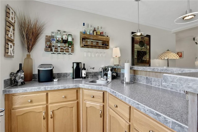 bar with decorative light fixtures, light brown cabinets, ornamental molding, and sink