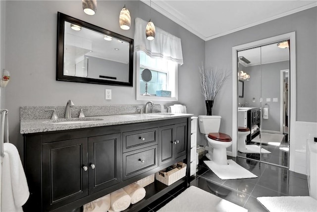 bathroom with tile patterned flooring, vanity, toilet, and ornamental molding