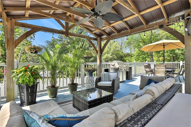 view of patio / terrace featuring an outdoor living space, a deck, ceiling fan, and grilling area