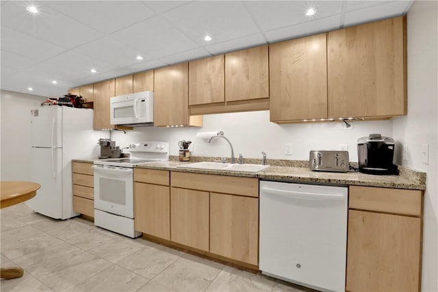 kitchen featuring a paneled ceiling, light brown cabinets, white appliances, sink, and light stone counters