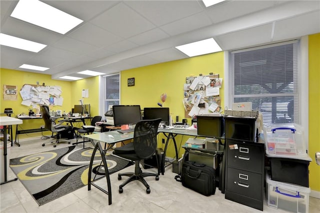 home office featuring a drop ceiling and light tile patterned floors