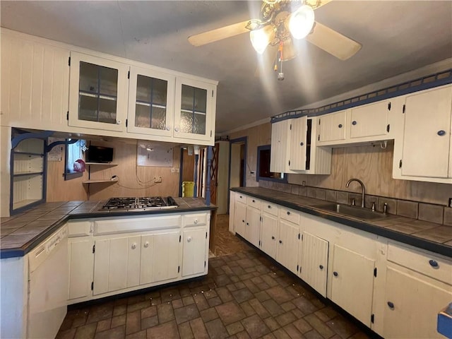 kitchen featuring white cabinetry, tile counters, sink, ceiling fan, and stainless steel gas cooktop