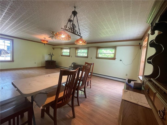 dining room featuring crown molding, light hardwood / wood-style floors, and a baseboard heating unit