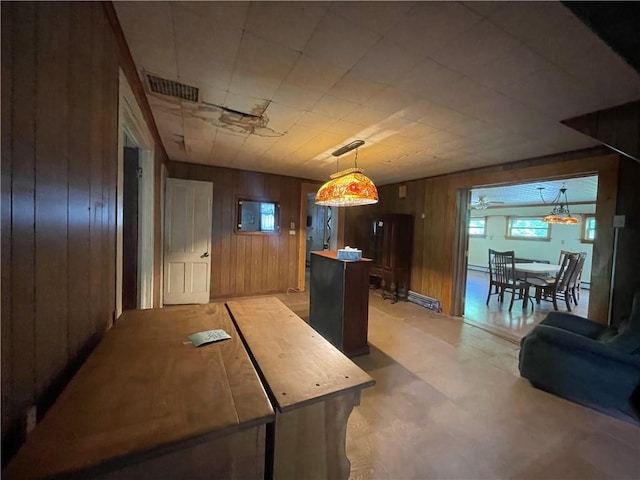 kitchen featuring wood walls and ceiling fan