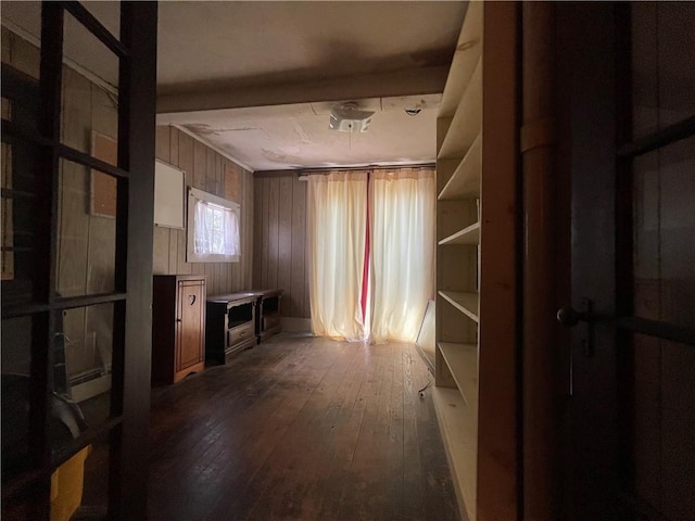 misc room featuring hardwood / wood-style flooring and wooden walls