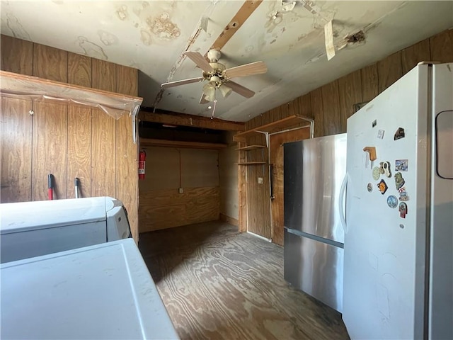 washroom featuring ceiling fan, washer / dryer, and wooden walls