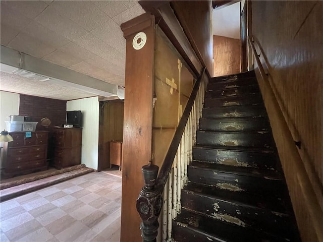 stairs featuring wooden walls