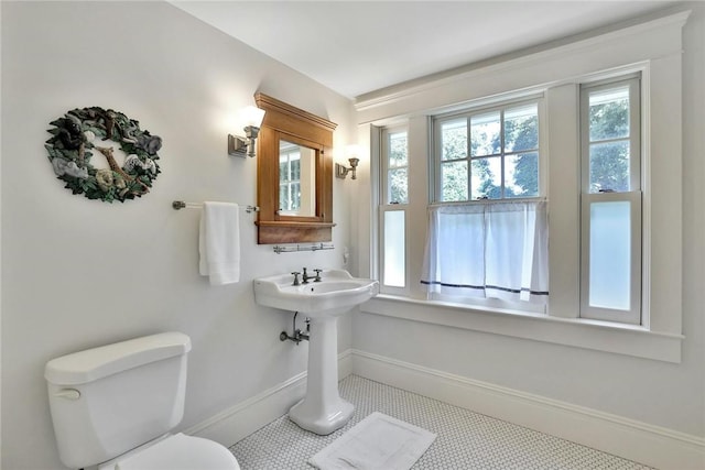 bathroom featuring plenty of natural light, tile patterned flooring, and toilet