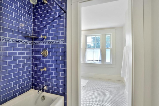 bathroom featuring tiled shower / bath combo and tile patterned floors