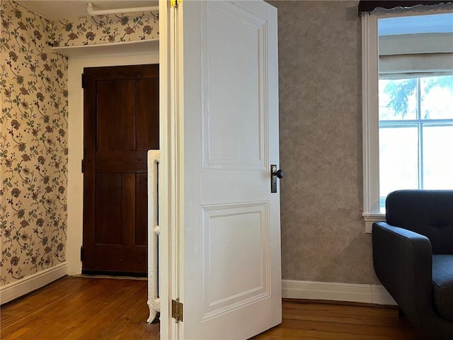 hall with hardwood / wood-style floors