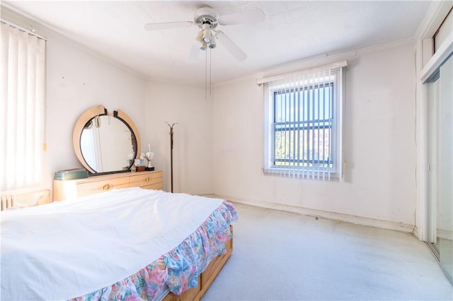 bedroom featuring carpet floors, a closet, ceiling fan, and crown molding