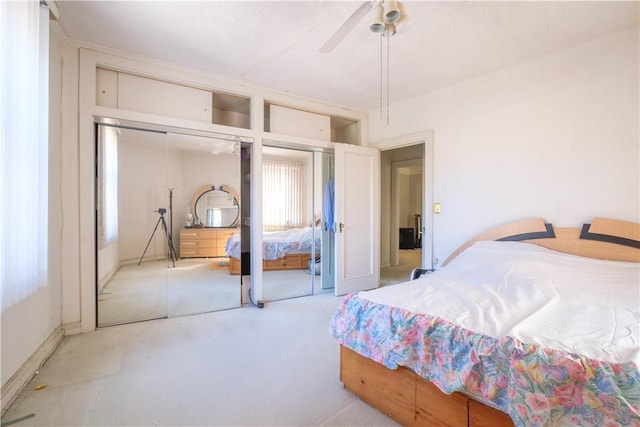 bedroom featuring ceiling fan and multiple closets