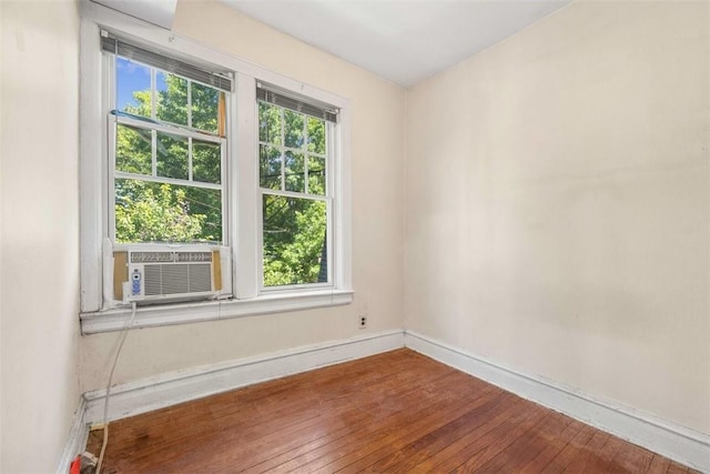 empty room with hardwood / wood-style flooring and cooling unit