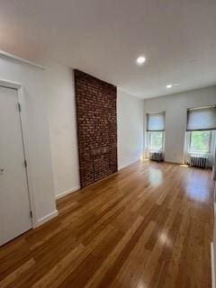 unfurnished living room with a fireplace and wood-type flooring