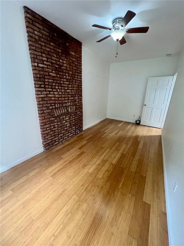 unfurnished room with ceiling fan and light hardwood / wood-style floors