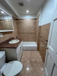 bathroom with tile patterned flooring, vanity, toilet, and a shower