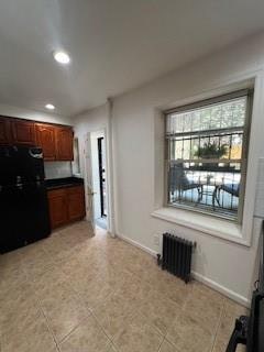 kitchen featuring black fridge and radiator