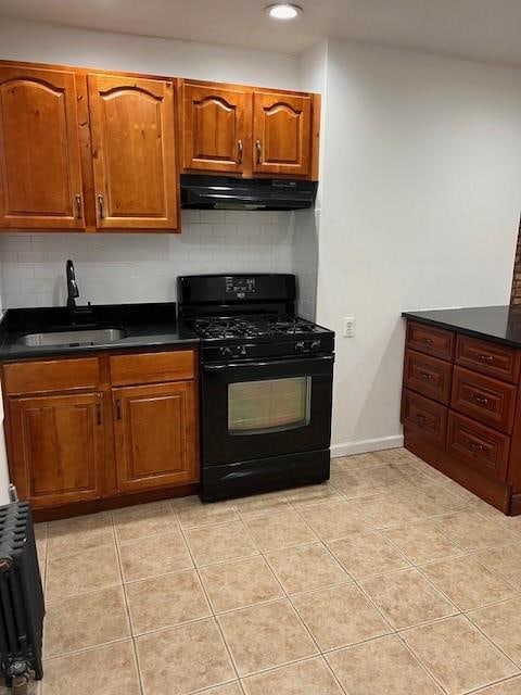 kitchen featuring light tile patterned flooring, sink, black range with gas cooktop, and tasteful backsplash