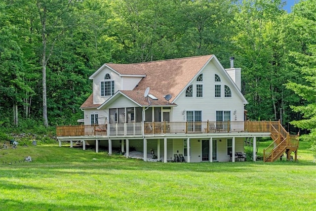 back of house featuring a lawn and a wooden deck