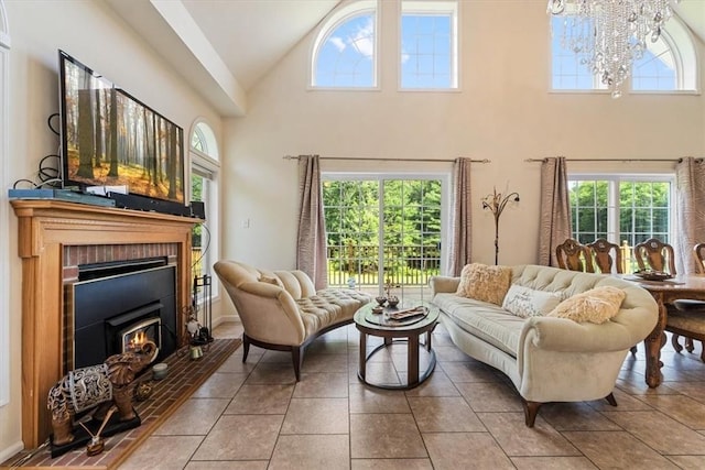 living room with a chandelier, light tile patterned floors, high vaulted ceiling, and plenty of natural light