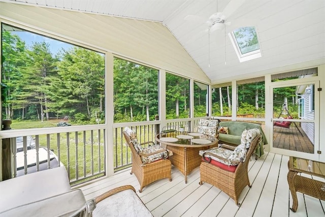 sunroom / solarium with ceiling fan, lofted ceiling with skylight, and a wealth of natural light