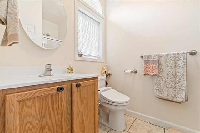 bathroom featuring tile patterned flooring, vanity, and toilet