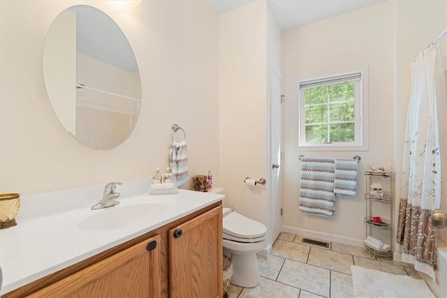 bathroom featuring tile patterned floors, vanity, and toilet