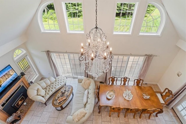 dining space with a towering ceiling and a notable chandelier