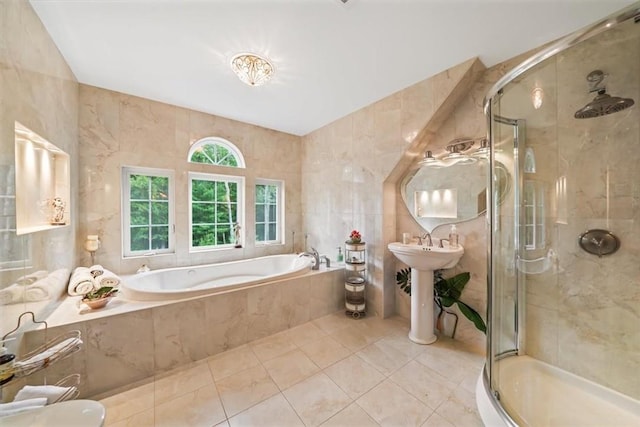 bathroom with tile patterned flooring, separate shower and tub, and tile walls