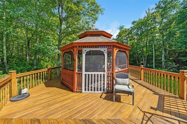 deck with a gazebo and a sunroom