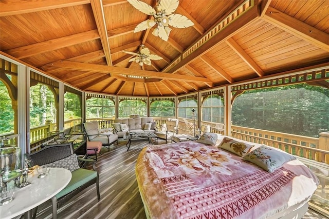 sunroom with vaulted ceiling with beams, ceiling fan, and wood ceiling