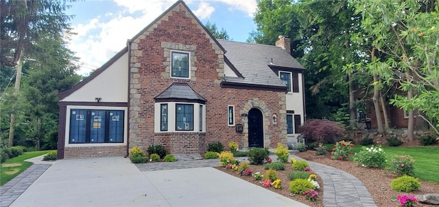 tudor house featuring a patio area