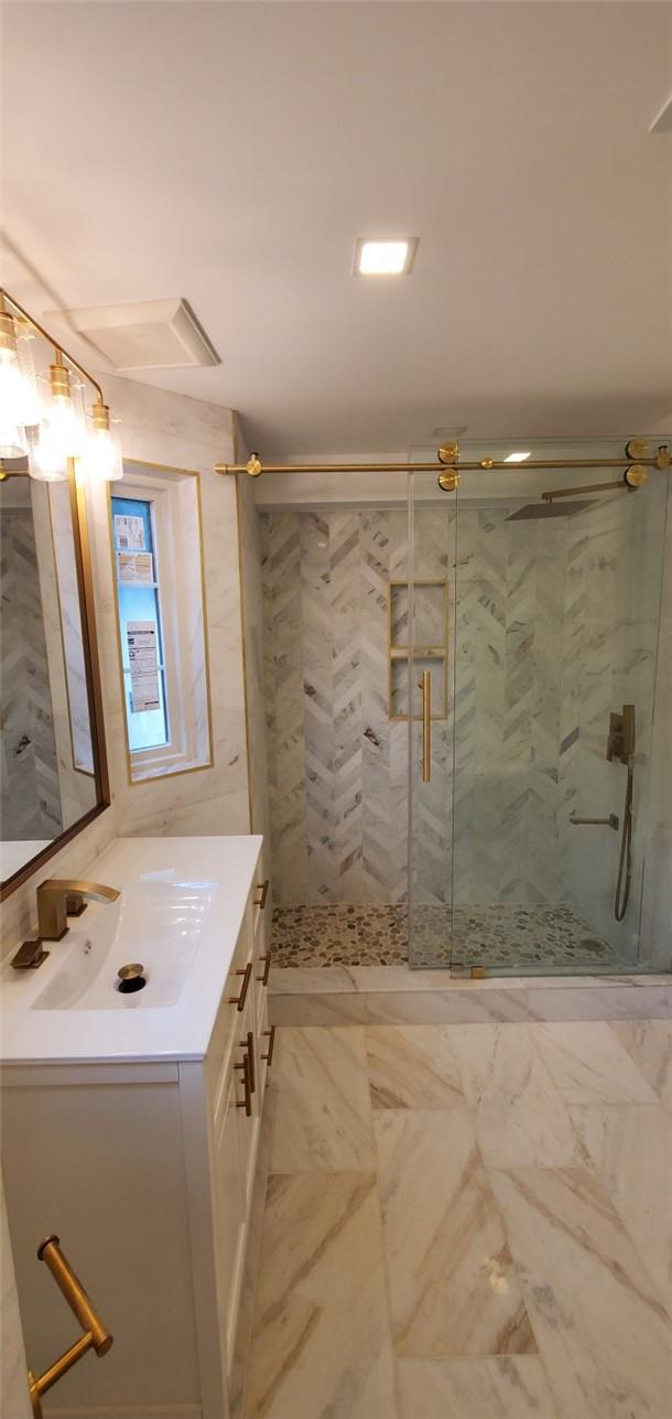 bathroom featuring vanity and walk in shower