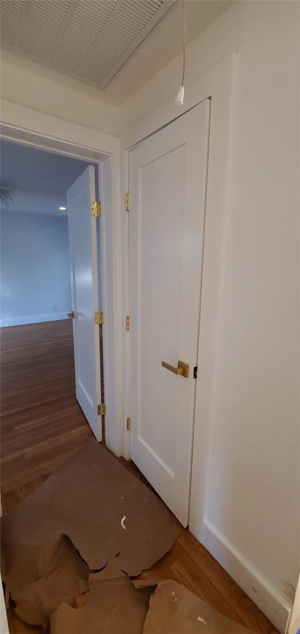 hallway with hardwood / wood-style flooring