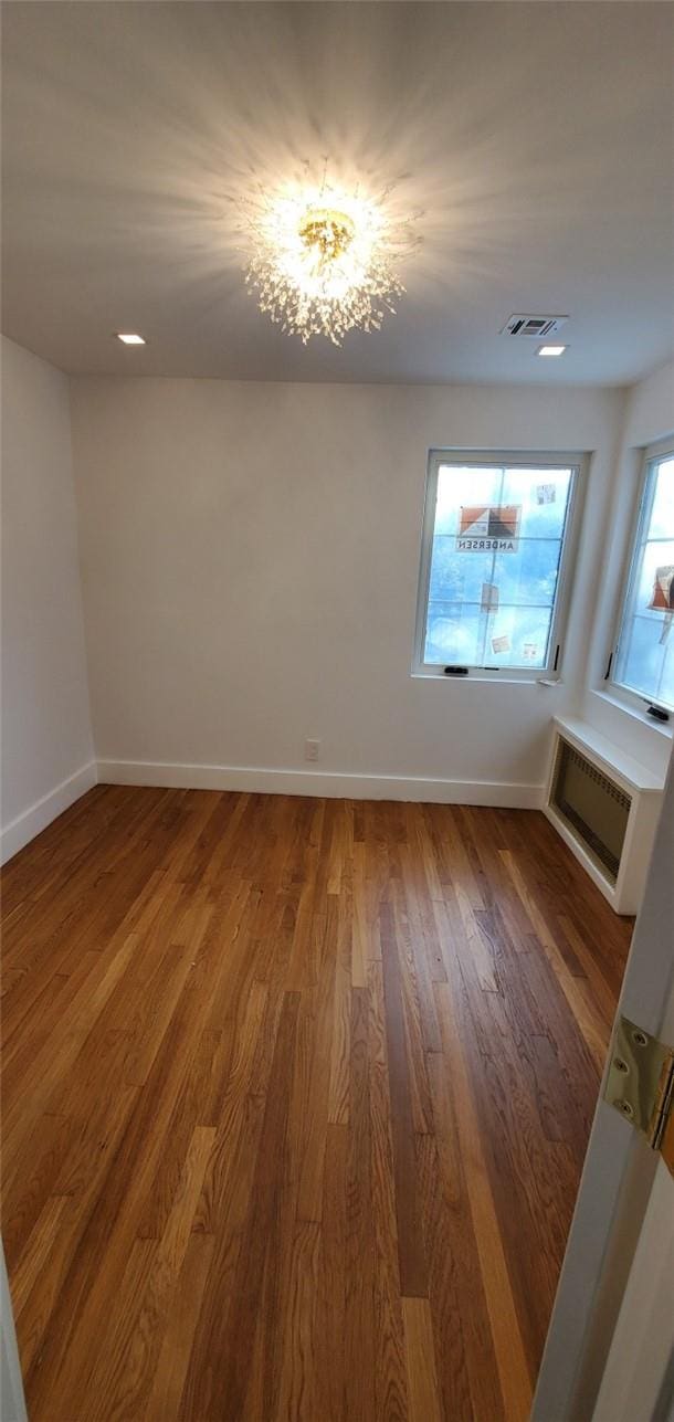 unfurnished room featuring hardwood / wood-style flooring