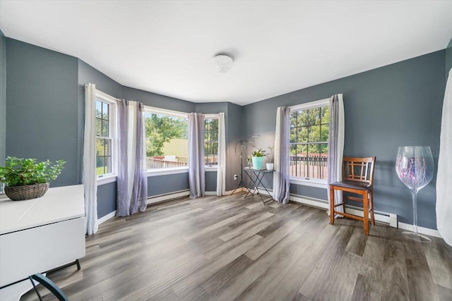 interior space with hardwood / wood-style floors and baseboard heating