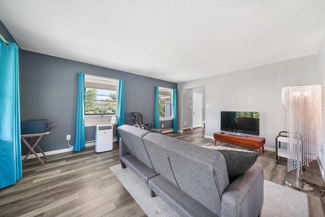 living room featuring wood-type flooring and a baseboard radiator