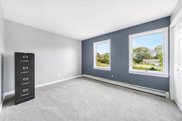 interior space with baseboard heating and light carpet