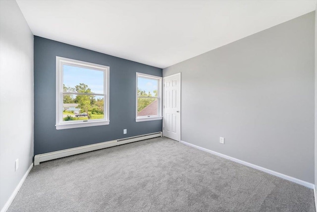 carpeted spare room featuring a baseboard radiator