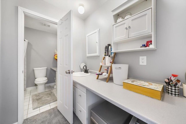 bathroom featuring tile patterned floors, vanity, and toilet