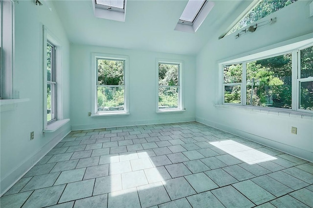 unfurnished sunroom featuring lofted ceiling with skylight