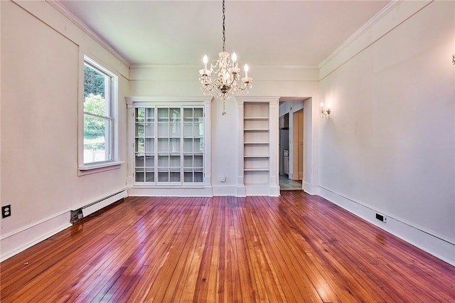 unfurnished dining area with ornamental molding, a baseboard heating unit, hardwood / wood-style floors, and an inviting chandelier