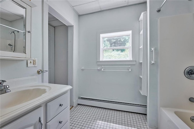 bathroom with baseboard heating, vanity, and shower / washtub combination