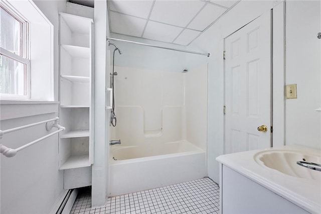 bathroom with a paneled ceiling, vanity, tub / shower combination, and tile patterned flooring