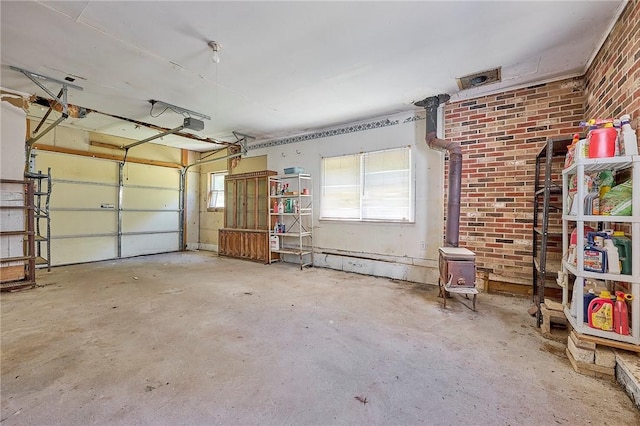 garage with a garage door opener and a wood stove