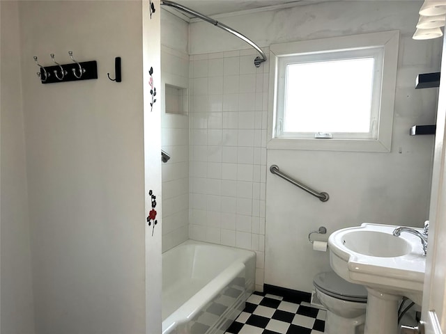 bathroom with toilet and tiled shower / bath combo