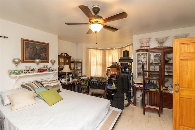 bedroom with light hardwood / wood-style floors and ceiling fan