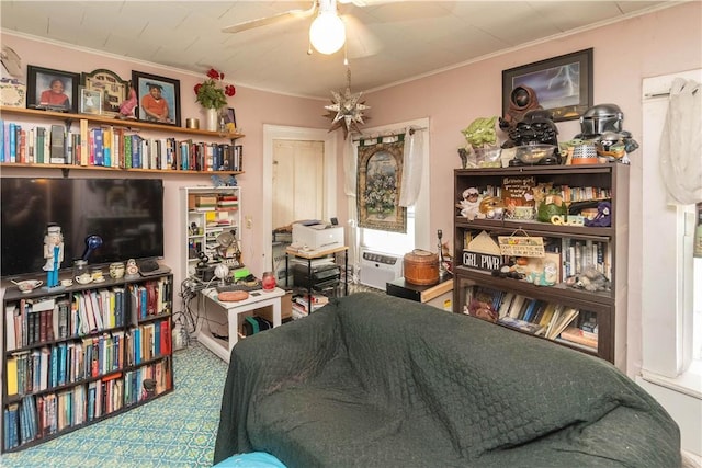 living area featuring ceiling fan and crown molding