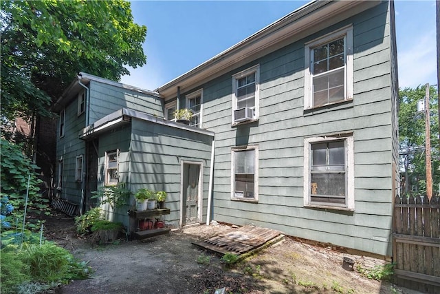 back of house featuring cooling unit