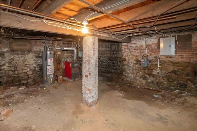 basement featuring electric panel and water heater